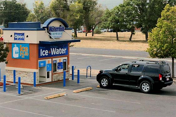 Customer parked out front of a Watermill Express refill station